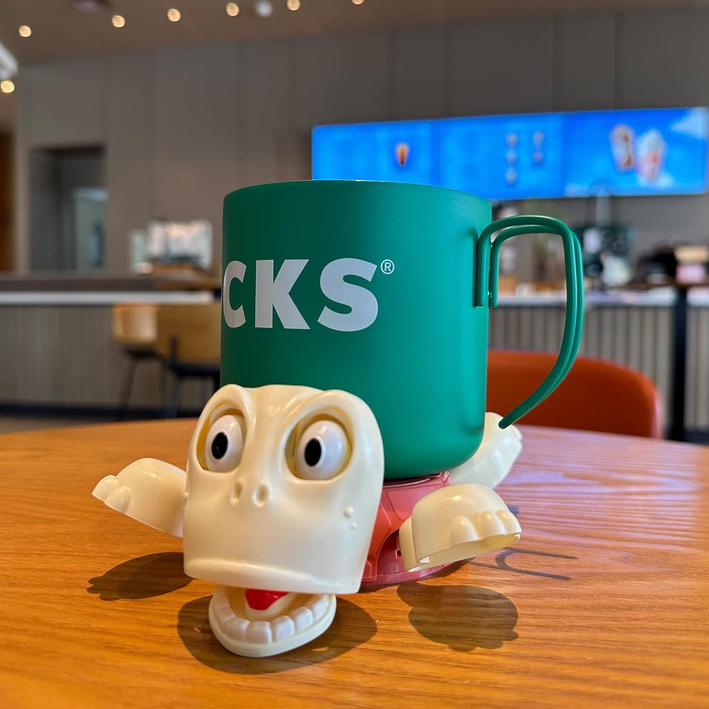 Funny turtle-shaped coaster holding a coffee mug